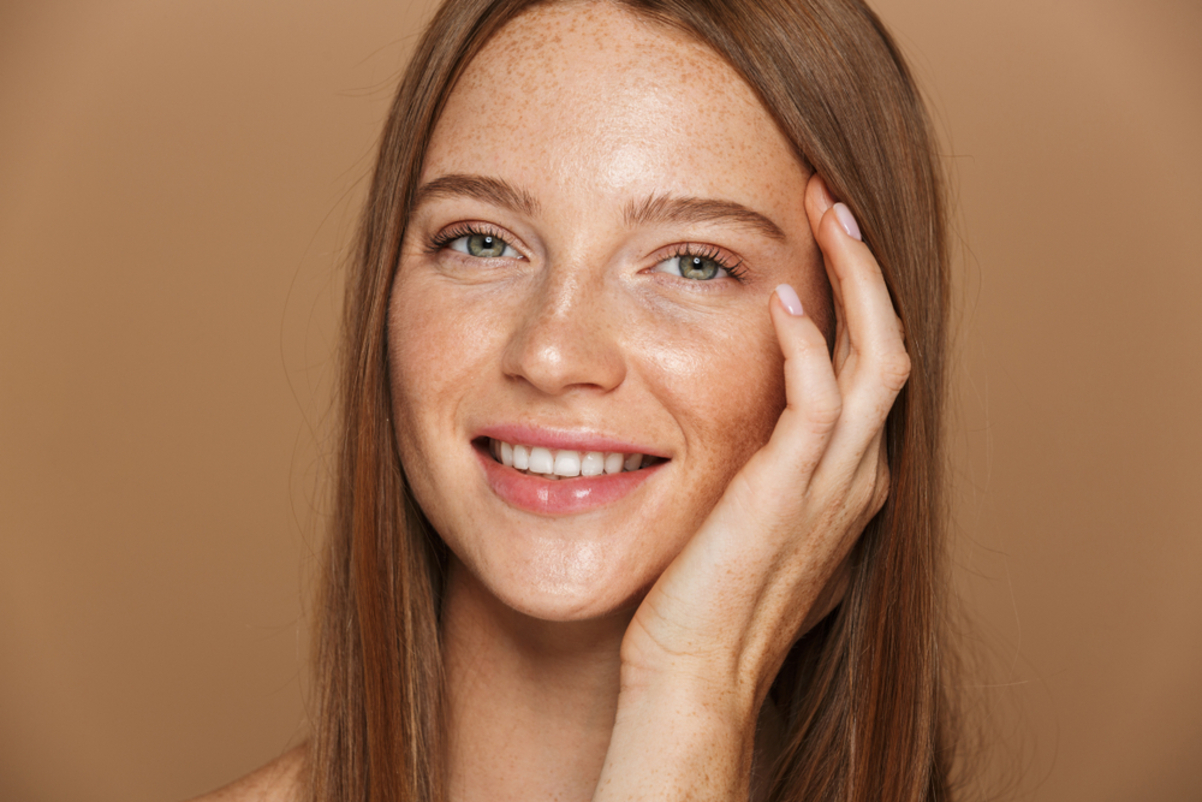 Portrait of woman with glowy skin smiling