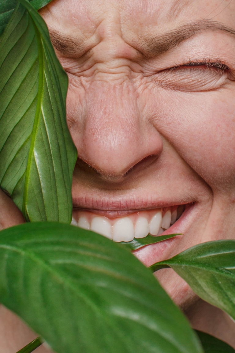Person biting plant closeup 