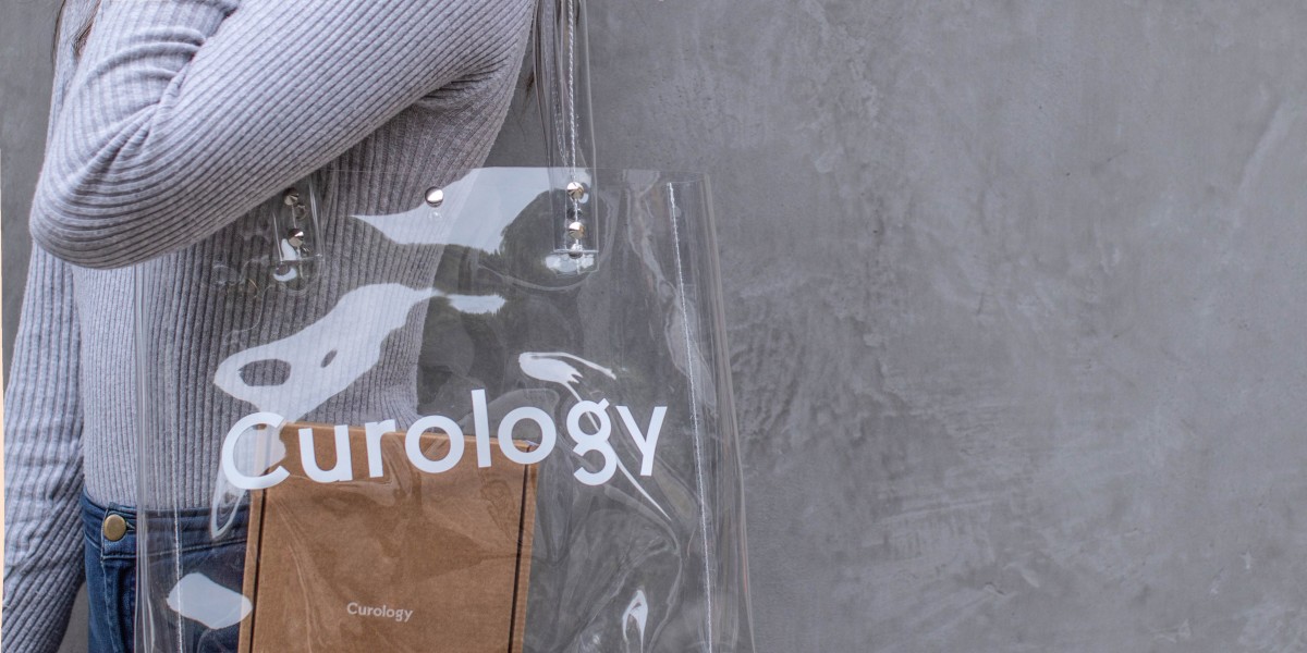 person holding clear curology bag
