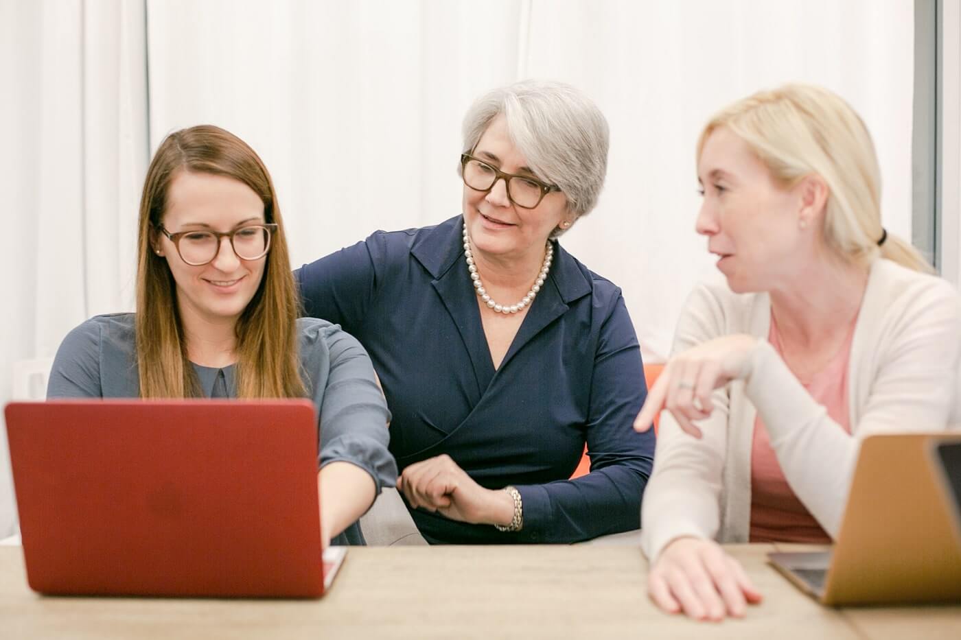 Nancy Satur speaking with two women