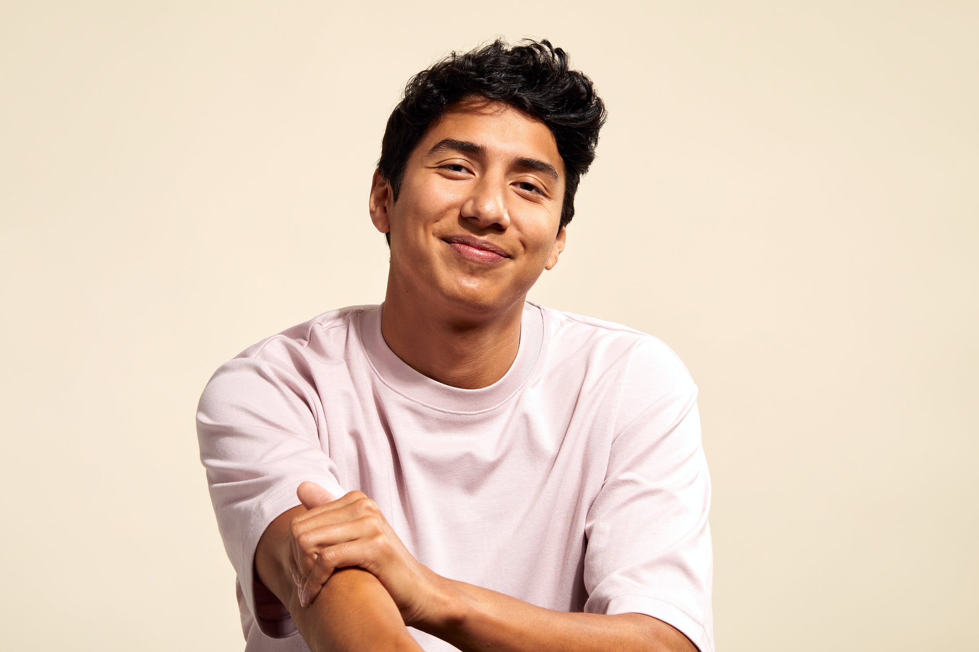 Men smiling on yellow background