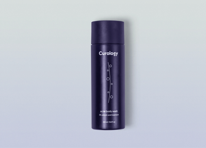 Curology Acne Body Wash bottle against a neutral gray background
