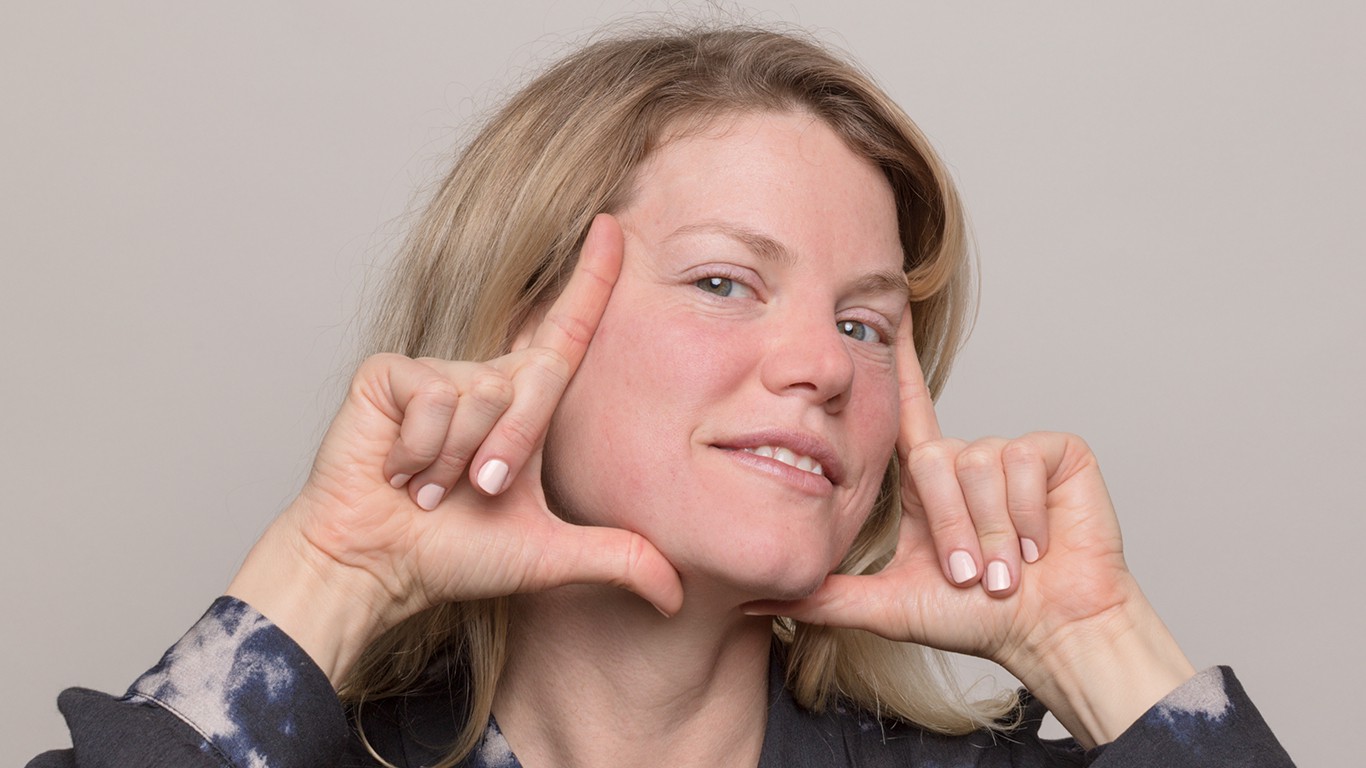 Woman holding fingers to frame her face