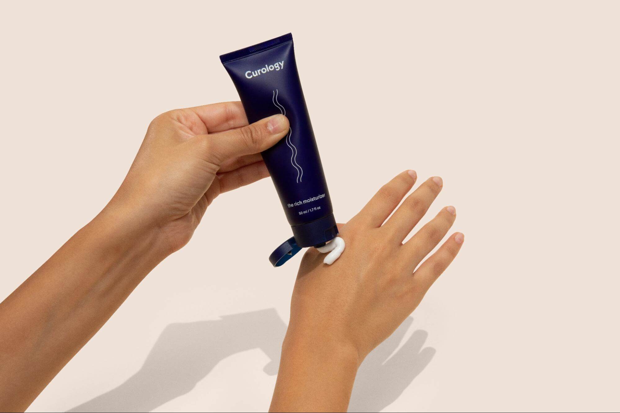 Applying Curology-s Rich Moisturizer on the Hand