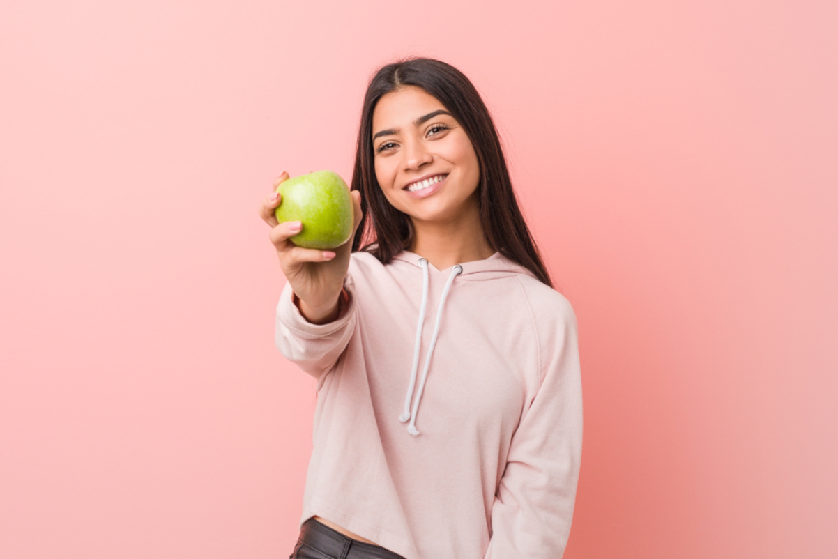 young woman eating apple