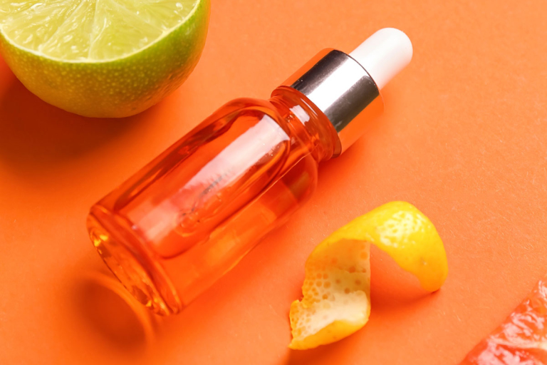 Vitamin-C-Skincare-Serum-over-orange-background