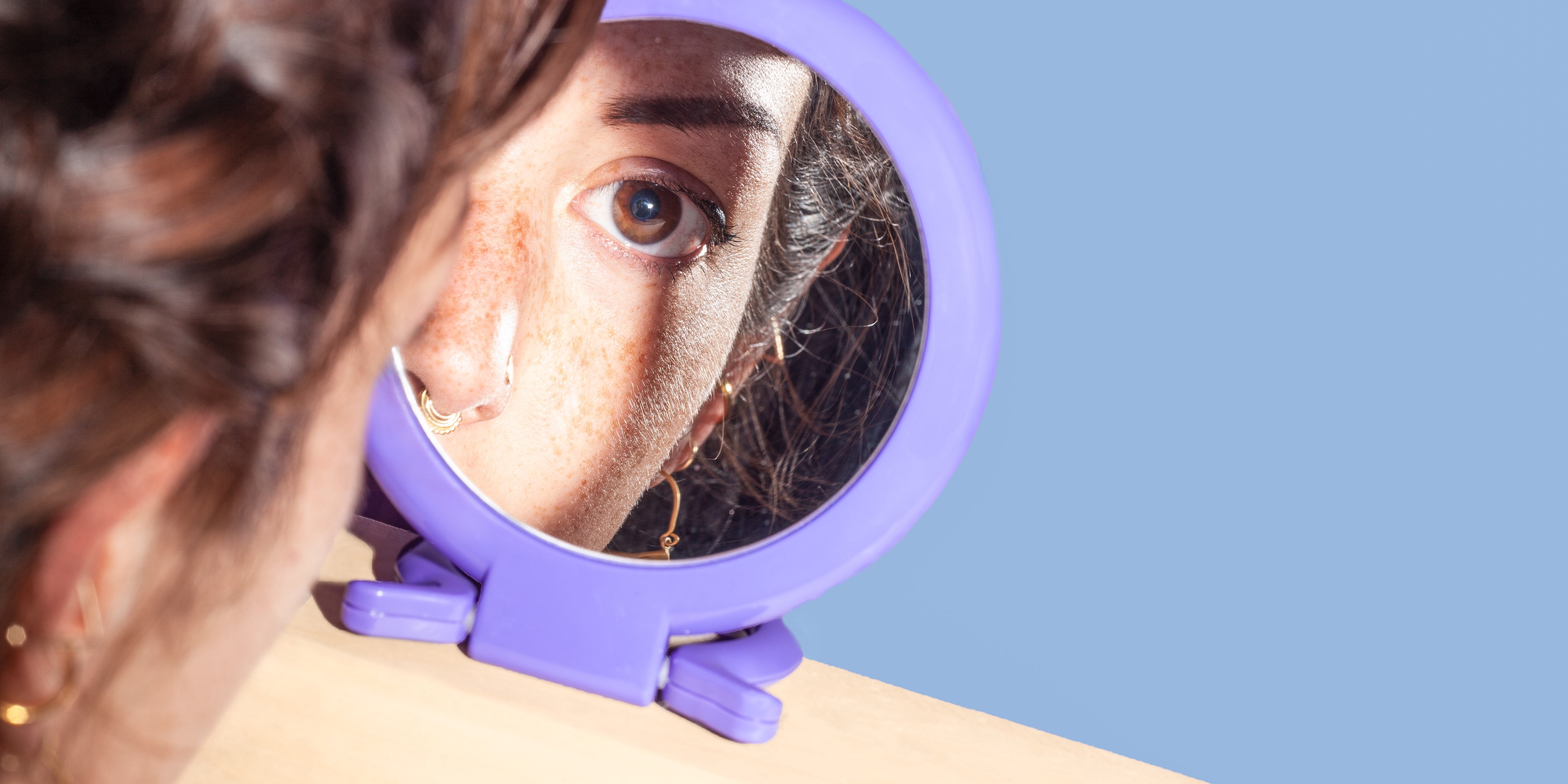 Woman looking into mirror