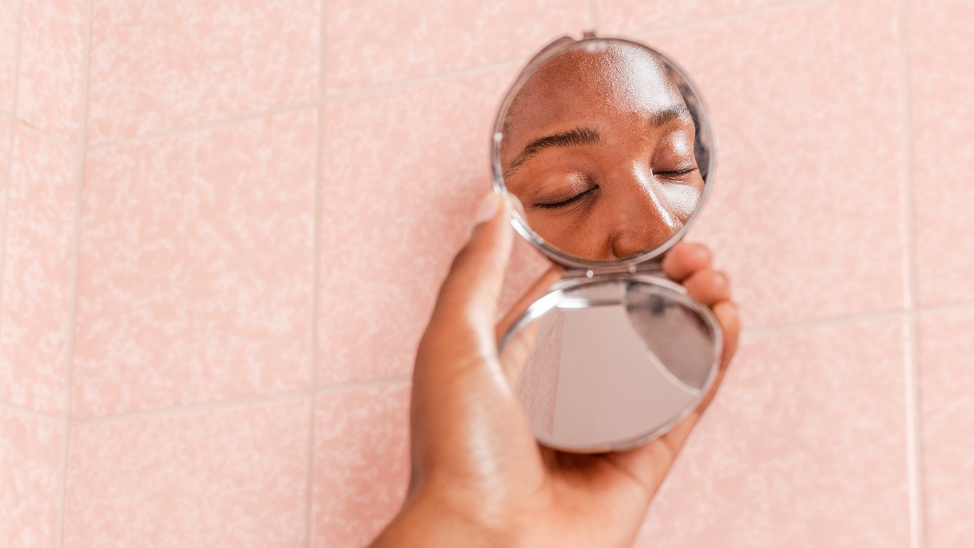Woman's reflection in mirror (only showing eyes)