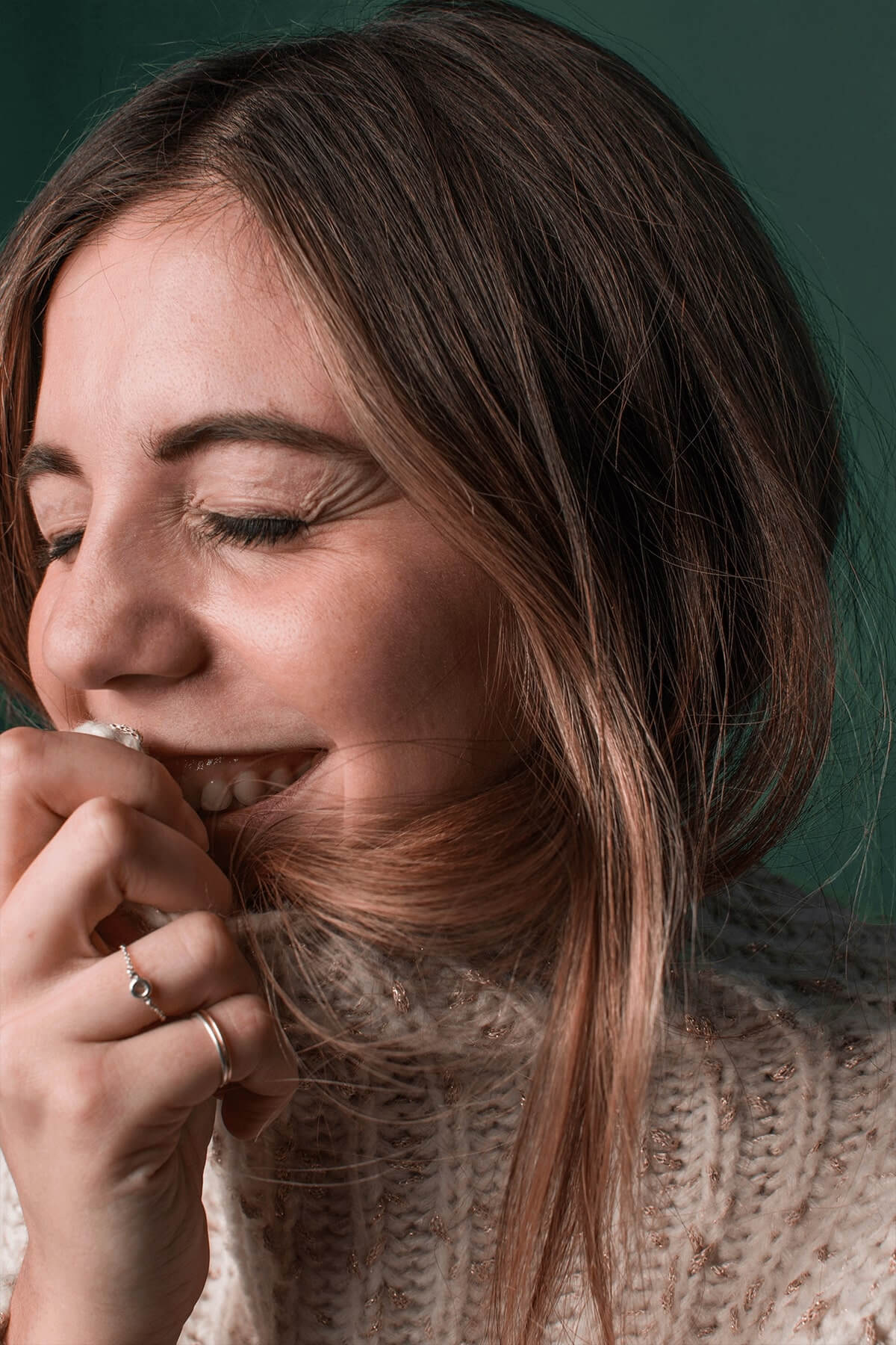 Woman laughing with green background