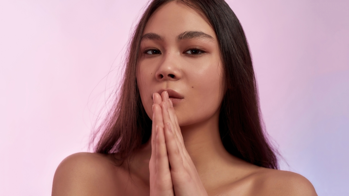woman in front of a pink background