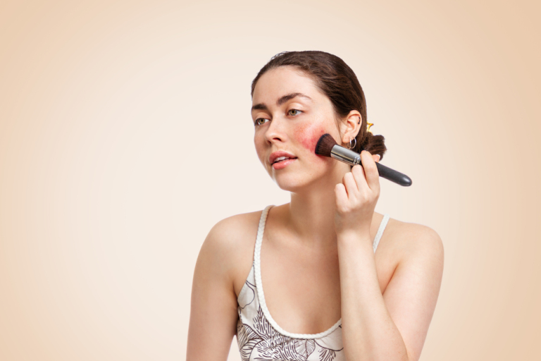 Young-pretty-woman-applies-makeup-brush