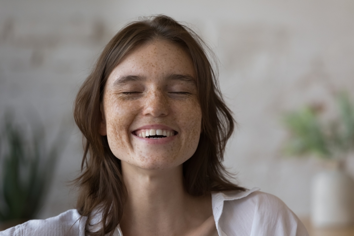 happy woman with freckles smiling