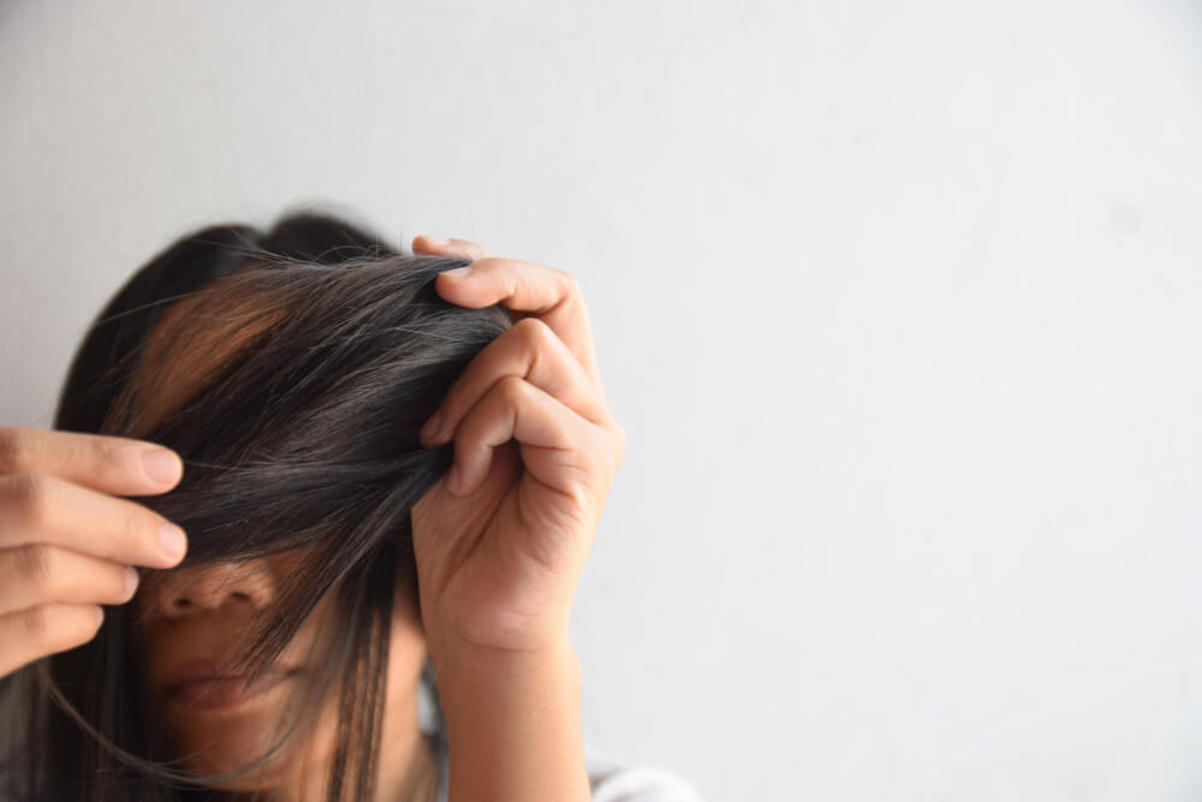 Woman Examining Hair