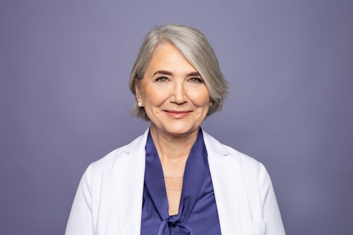 Dr. Nancy Satur in front of purple background