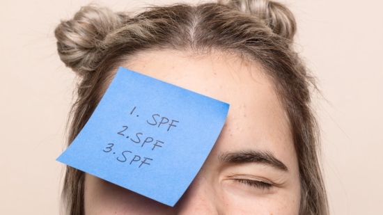 Woman with spf sticky note on her face
