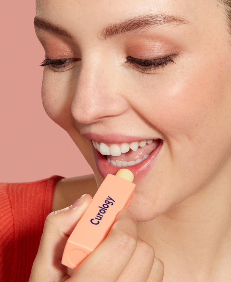 Image of woman applying lip balm to lips