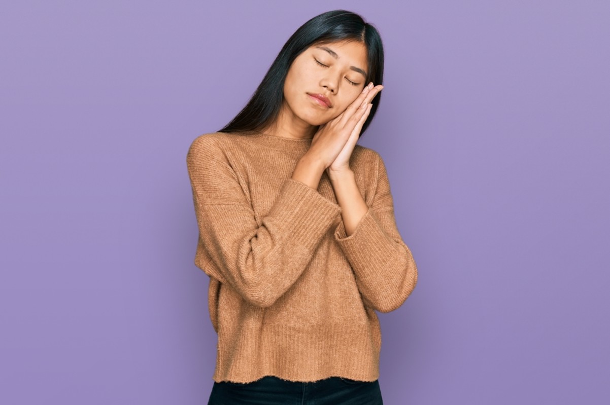young woman pretending to be sleep