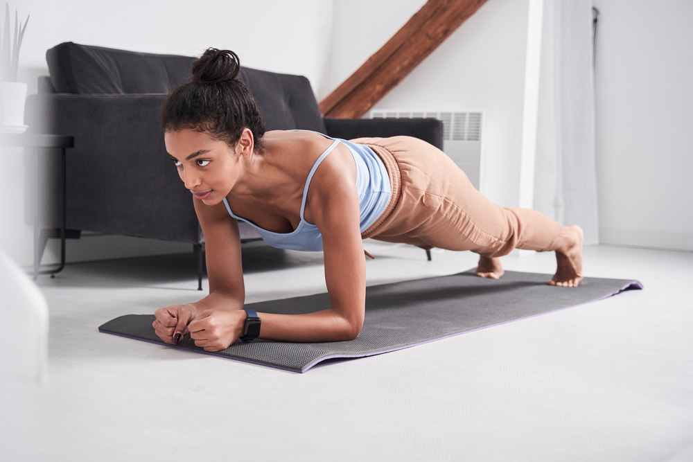 Fit woman exercising at home