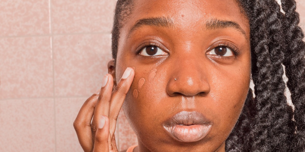 Woman adding foundation closeup