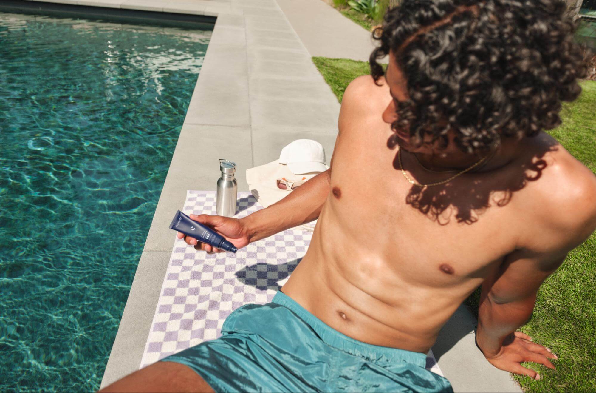 A Man Holding Curology's Sunscreen
