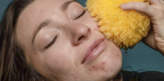 Woman with sponge on her face