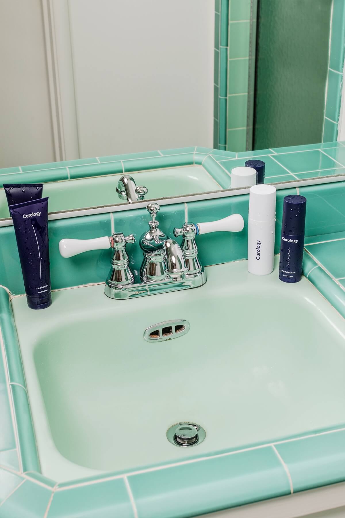 Green sink with curology bottles 