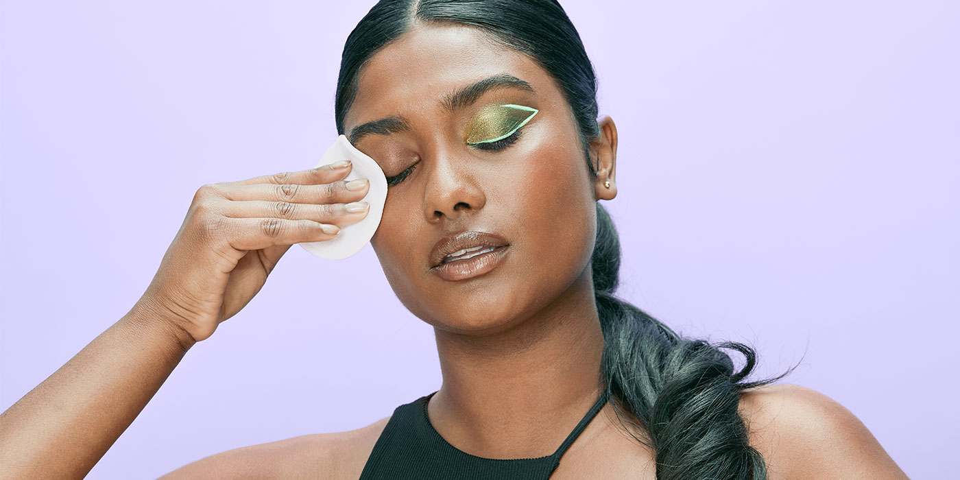 Woman removing makeup with micellar water makeup remover