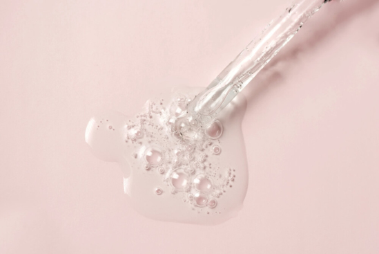Liquid Oil Serum Drop in Pipette Isolated on Pastel Pink Background