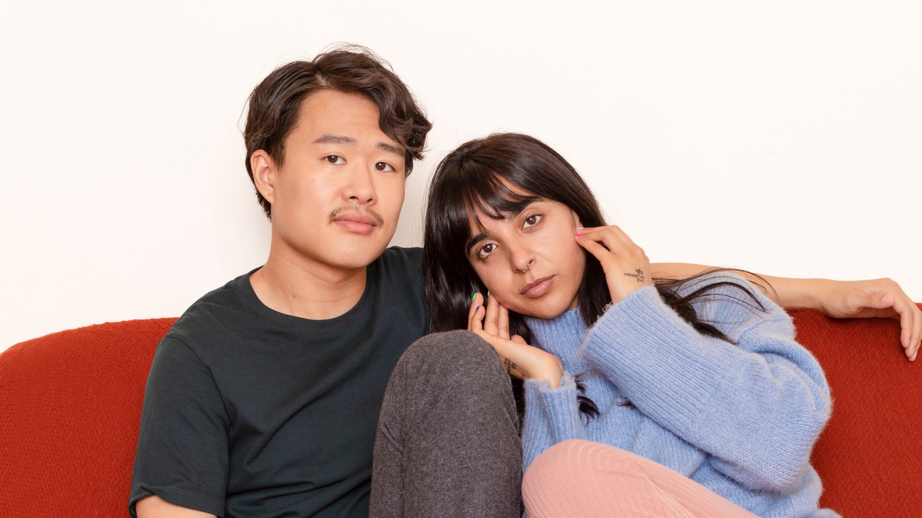 Couple sitting on red couch