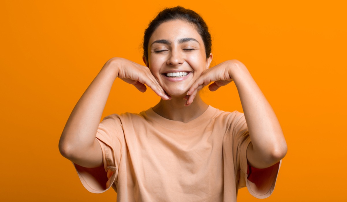 Happy young woman with orange background