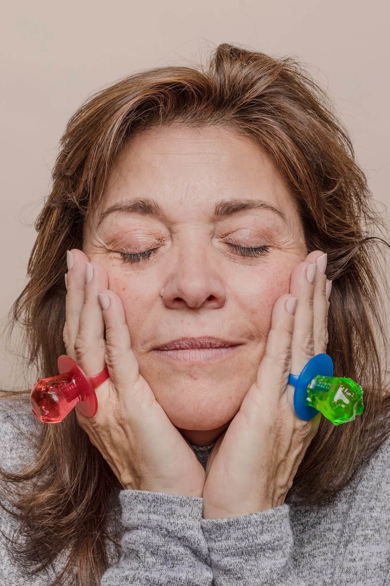Woman touching her face wearing ring pops