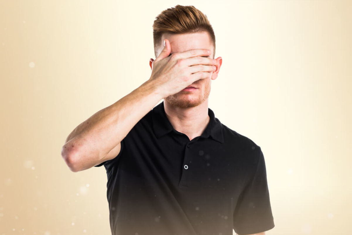 Man Covering Eyes