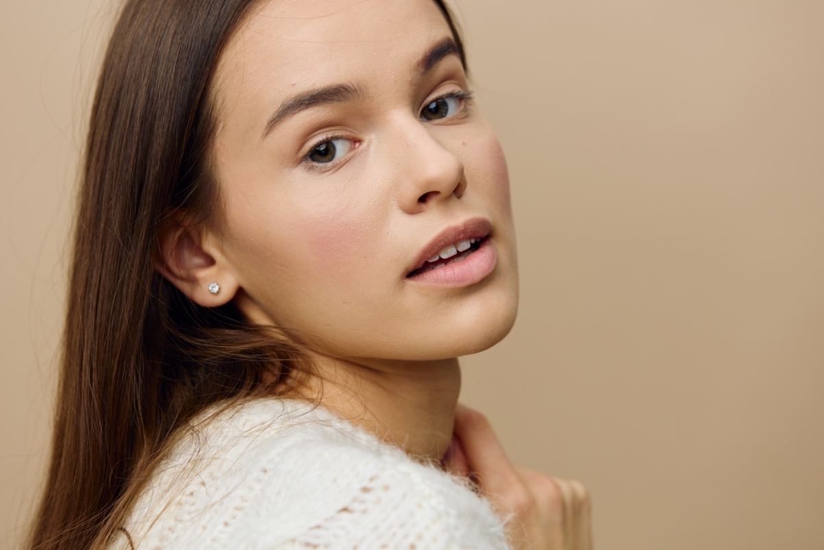 elegant woman stands on light