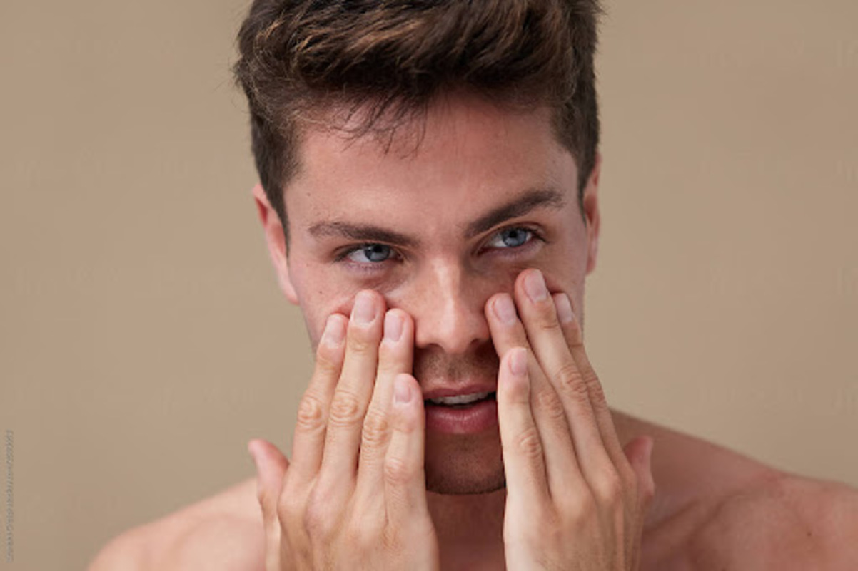 Man touching his face