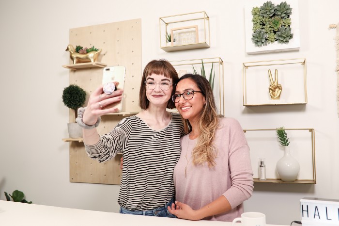 Women smiling and taking selfie