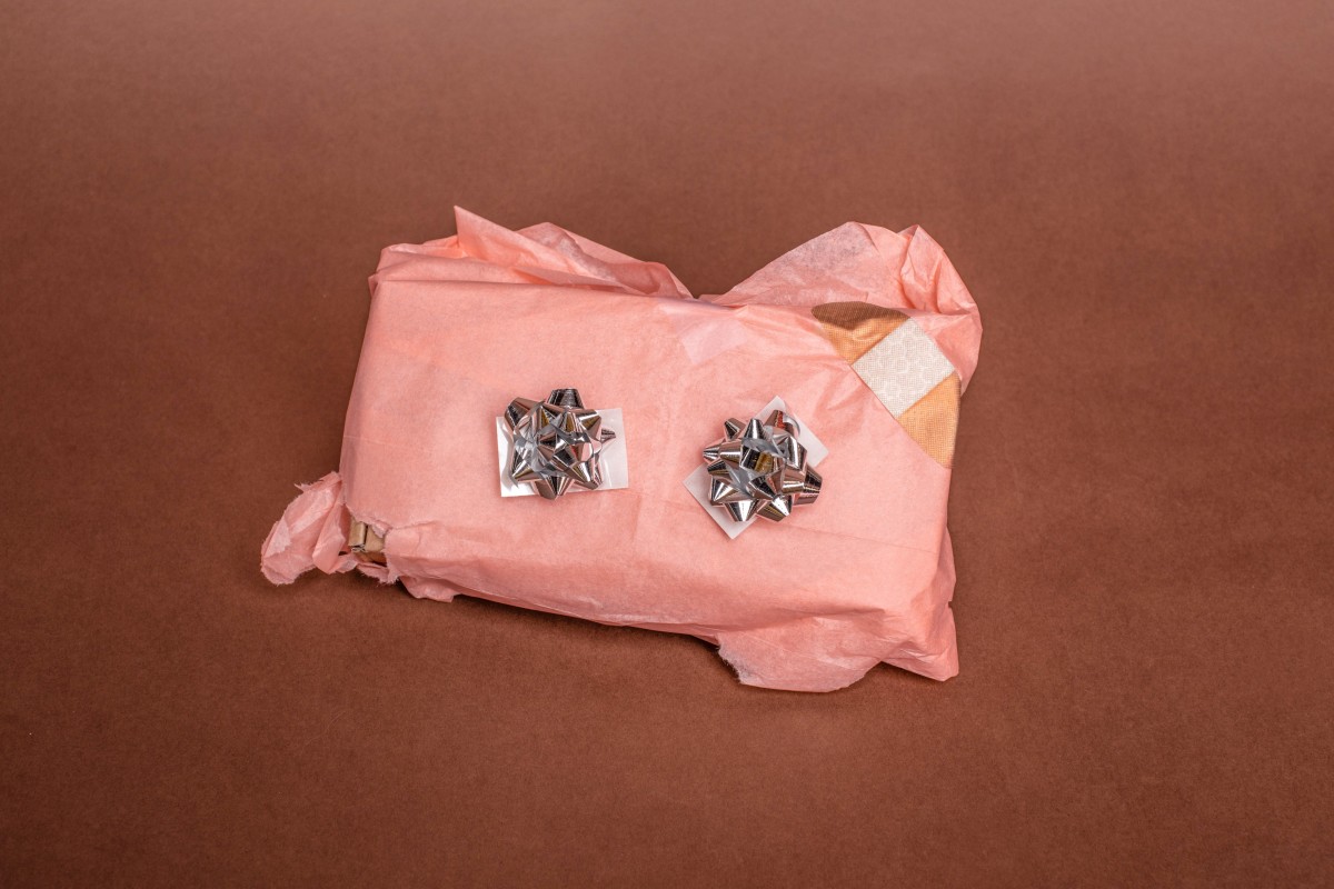 Gift wrapped in pink wrapping paper with silver bows