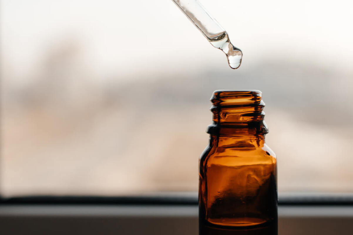 Serum in Pipette Dropping Into Bottle