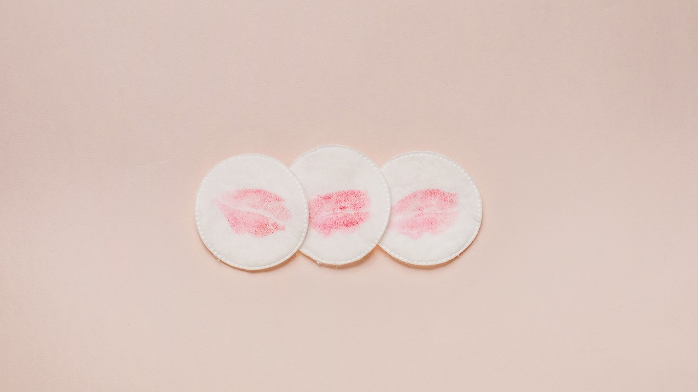 Cotton pads with red lipstick marks on them