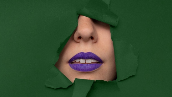 Image of purple lips with green background