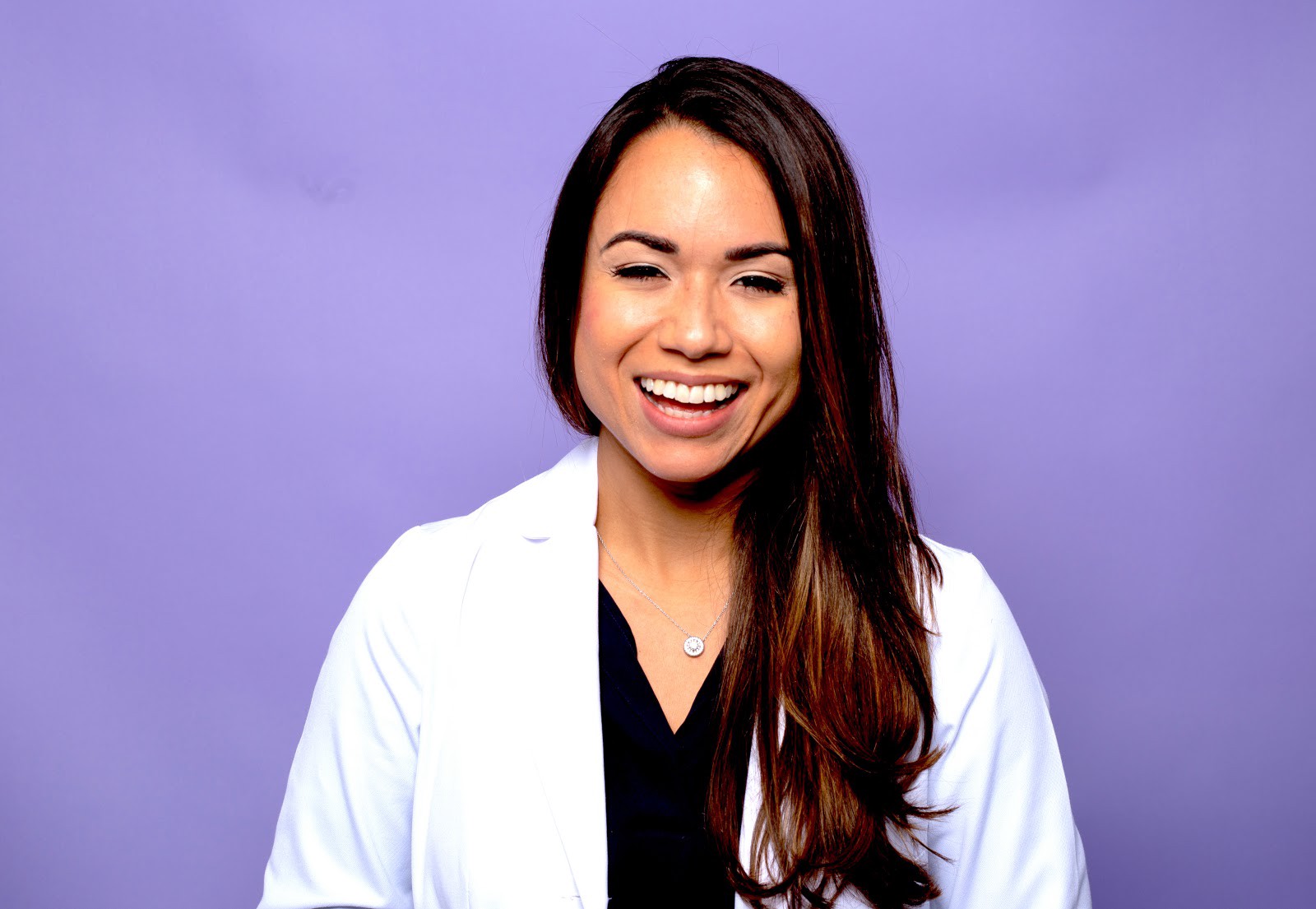 Woman smiling with purple background