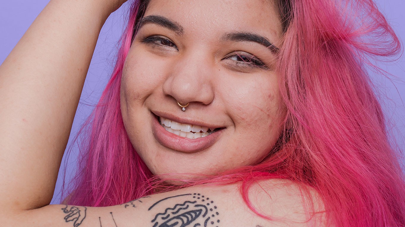 Woman with pink hair smiling 
