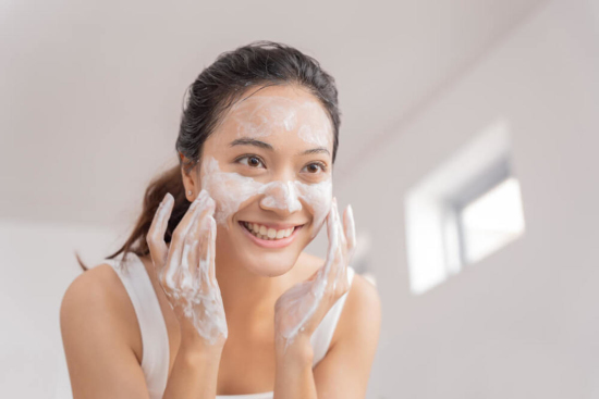 Cheerful Woman Scrubbing Face