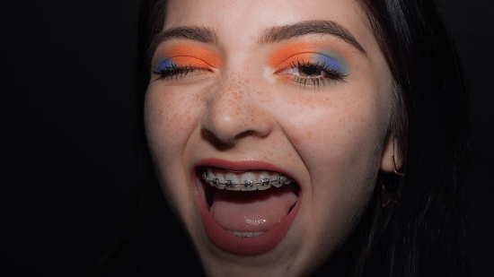 Woman with orange and blue eyeshadow