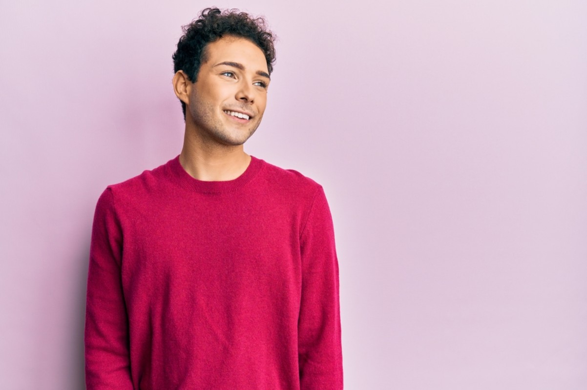 smiley man leaning on a wall