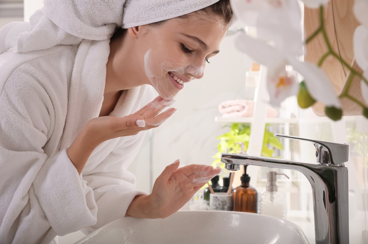 young woman washing face