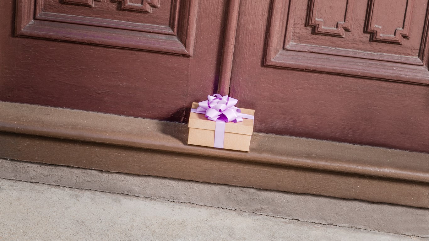 Package with purple box sitting at door step