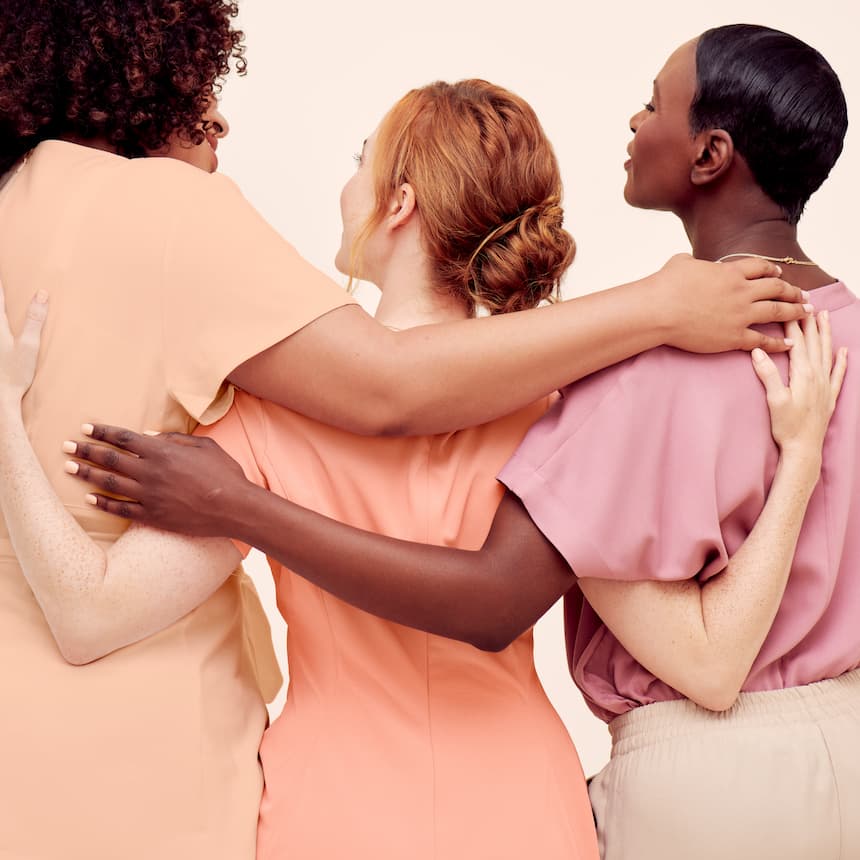 a diverse group of women hugging