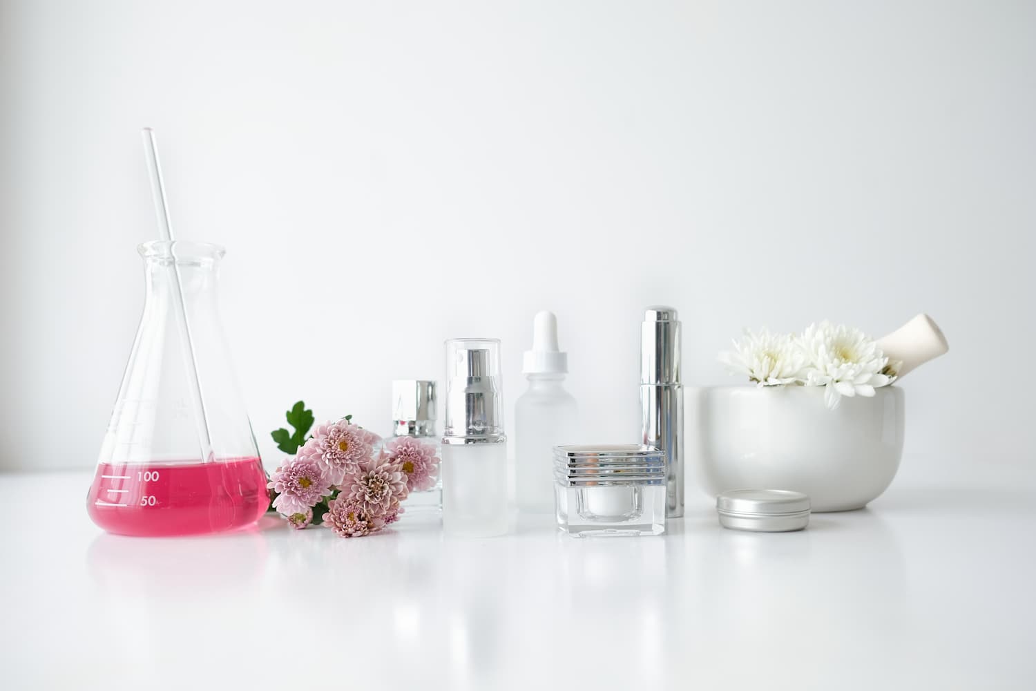 Collection of bottles and containers on white countertop