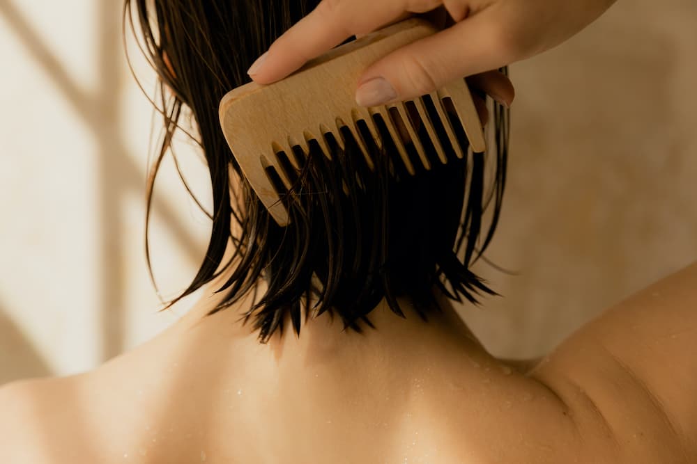 Woman combing her wet hair