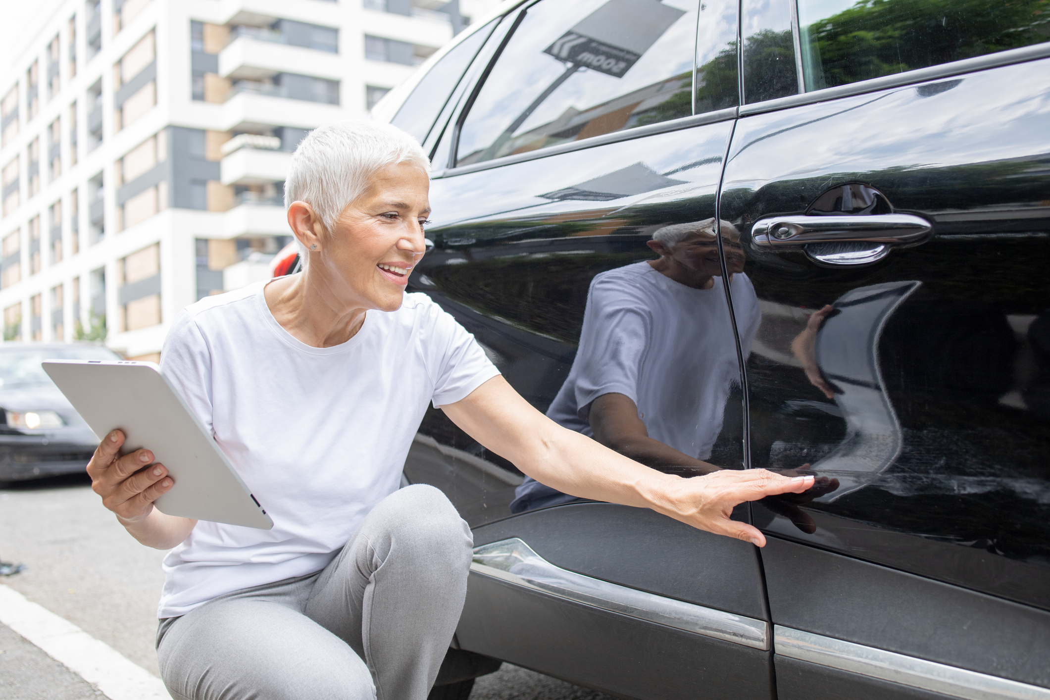 Woman inspecting a car